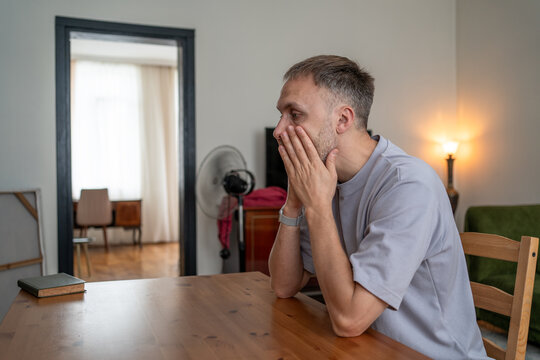 Man under stress from job insecurity, money anxiety, unemployment risk, career uncertainty, rising household expenses and economic pressure at home.