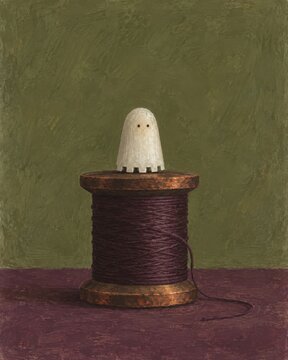 Halloween tailor's ghost balanced on a giant bobbin
