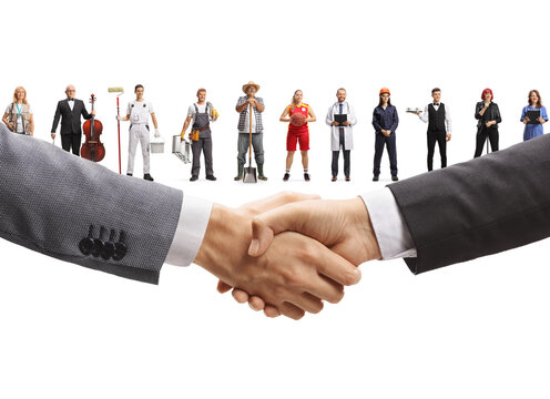Business handshake with various workers from different professions standing in the background