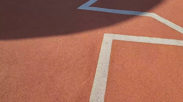 A calm walk along the orange path with a white zigzag pattern on the stadium.