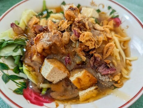 Traditional Indonesian ongklok Noodle Salad with Peanut Sauce and Fried Tofu