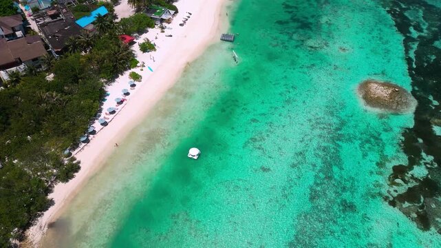 Aerial turquoise lagoon and white sand, floating gazebo in shallow clear water near coral patches, remote island shoreline, calm tropical atmosphere, drone panorama over maldives, Male