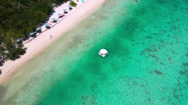 Aerial turquoise lagoon and white sand, floating gazebo in shallow clear water near coral patches, remote island shoreline, calm tropical atmosphere, drone panorama over maldives, Male