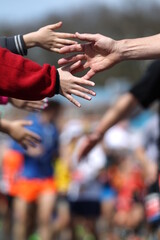 High-Five Between a Child and a Marathon Runner Along the Race Route © flysnow