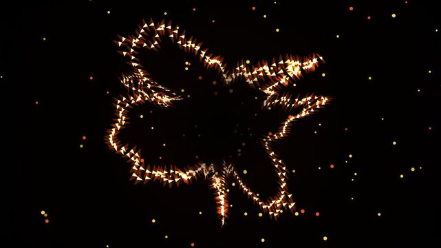 Abstract maple leaf outline shimmering with golden glow and floating particles on black back.