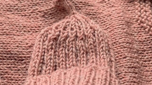 A close-up view of a pink knitted sweater