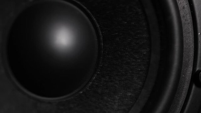 4K macro close-up footage of speakers reverberating with deep bass, showcasing powerful sound vibrations against a dark background