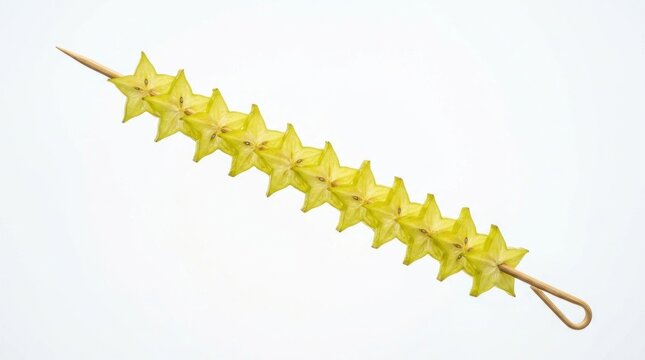 Sliced starfruit carambola pieces on a long wooden skewer.