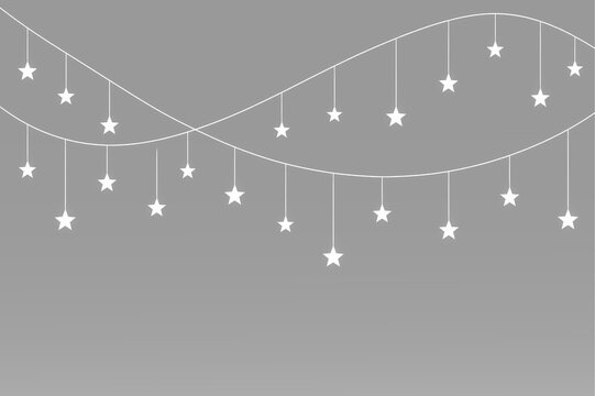 Festive white star lights suspended from smooth curved strings in a delicate decorative arrangement
