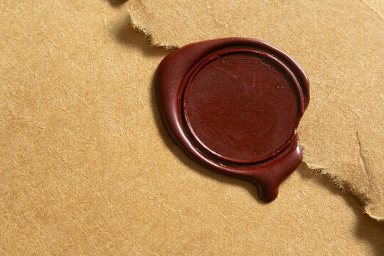 Close-Up Blank Red Wax Seal Stamped on Jagged Torn Edge Brown Envelope Flap for Vintage Correspondence and Invitation