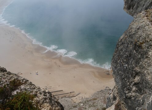 Big ocean waves below from high view of Praia do Norte in Nazar&eacute; Portugal