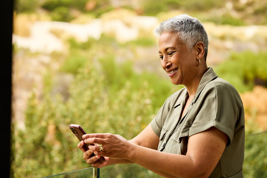 Smiling Woman texting Outdoors