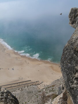 High up view of Praia do Norte or North Beach in Nazar&eacute; Portugal with big waves vertical photo