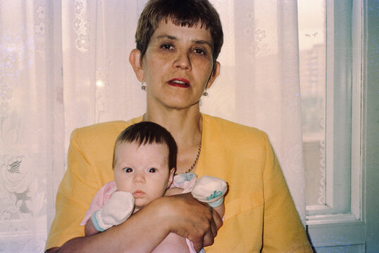 Grandmother holding a  newborn granddaughter