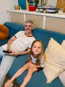 Family watching a football match together