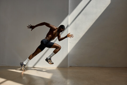 Runner in motion during training session inside gym