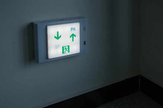 Illuminated Exit and Floor Indicator Sign on Wall