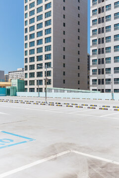 Rooftop Parking Lot with Modern High Rise Buildings