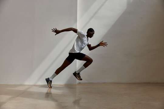 Runner moving fast in indoor space during daylight