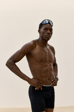Fitness model posing indoors with strong posture