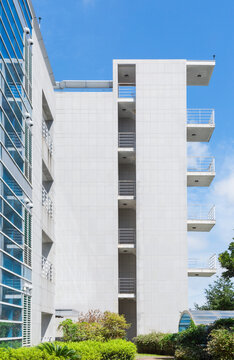 Modern Building Facade with Blue Glass Windows and Metal Balconies