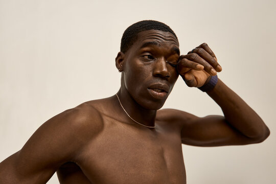 Man wiping his face during a studio session