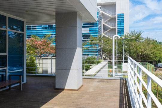 Modern Building Exterior View from Outdoor Wooden Deck Patio