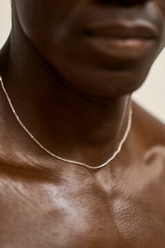 Close up of a person showing a silver necklace on their neck