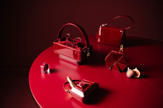 Red Leather Bags and Accessories On Table