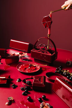 Luxurious Red Handbags and Candlelit Still Life