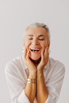 Senior woman laughing with closed eyes and joy