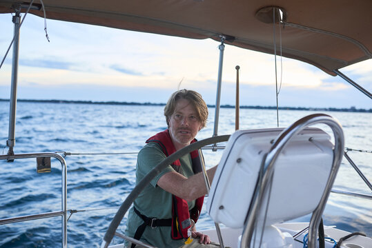 Man sailing at sunset