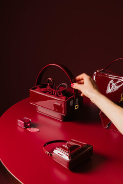 Red Luxury Handbag And Accessories On Table