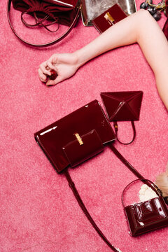 Glossy Red Handbags On Pink Carpet