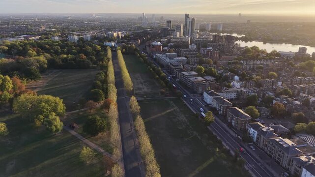 Aerial sunrise over Londons Finsbury Park and Seven Sisters Road, highlighting the West Reservoir in glowing morning light.