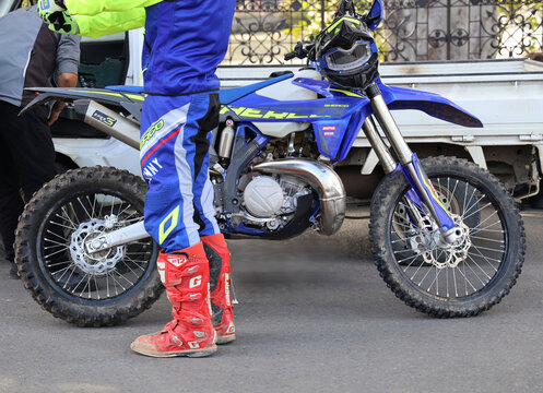Tbilisi, Georgia -04 October 2026: Sherco motocross enduro bike on motorcycle cross male motorcyclist wearing blue professional costume uniform red boots gaerne dirty Motorbike