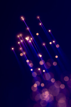 Vertical 3D luminous data beams and floating bokeh particles suggesting upward digital information flow