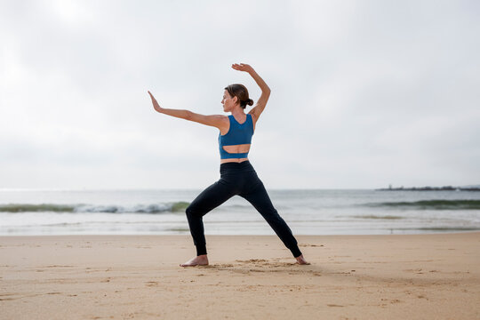 Woman Practicing Tai Chi on a Misty Beach