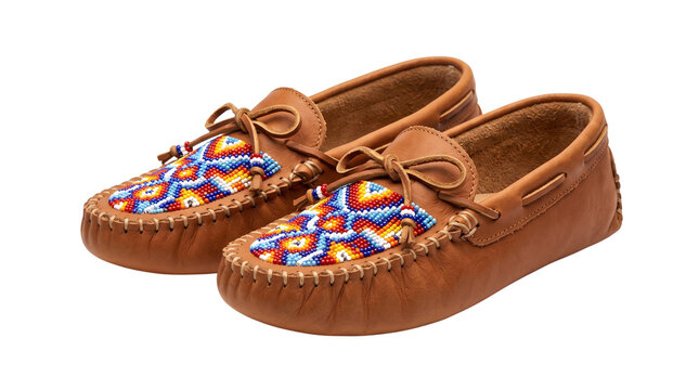 Traditional beaded leather moccasins with tribal pattern, handcrafted indigenous style footwear, authentic soft brown shoes isolated on white