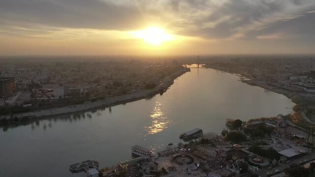 Drone flyover of the sun setting over the Tigris River in Baghdad, Iraq