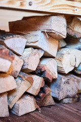 Fototapeta premium Stacked firewood stored under wooden bench inside sauna room. Close up