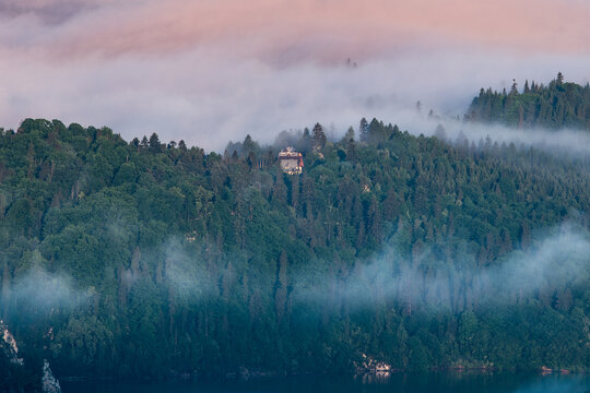 Majestic panoramic view of the Tatra Mountains landscape featuring snow-capped peaks, colorful forests, and picturesque valleys under a dramatic sky. Beautiful scenic nature and wilderness background