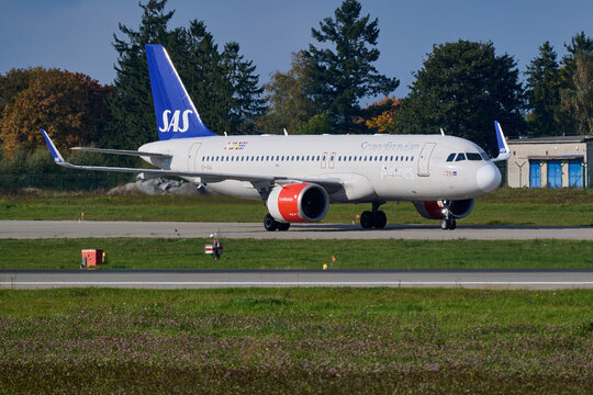 Scandinavian Airlines SAS aircraft taxiing along the runway with trees in background, Gdansk Airport, Gdansk, Poland, September 2026