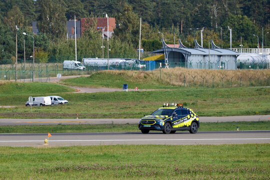 Yellow and black airport follow me service car driving on taxiway, Gdansk Airport, Gdansk, Poland, September 2026