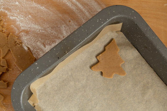 Christmas tree-shaped gingerbread cookie in the baking sheet
