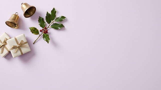 Christmas flat lay with golden bells holly sprig and gift boxes on a