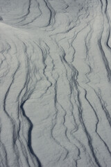 Abstract natural background of wave shaped snow dunes © Gherzak