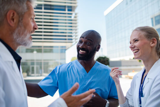 Medical team laughing together outside hospital