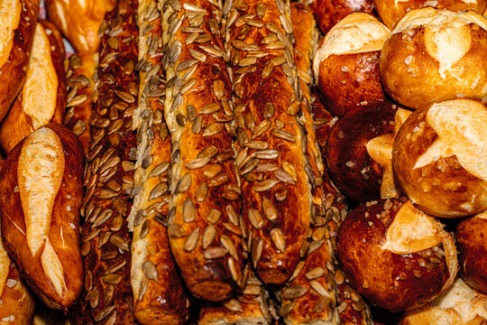 Variety of freshly baked breads, buns, and pastries displayed at an open buffet station.