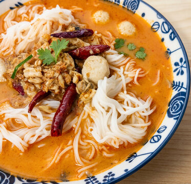 Thai Rice Noodles with Spicy Orange Curry, Dried Red Chilies and Fresh Herbs
